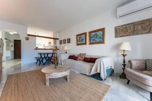 a living room with a couch and a table at Lovely apartment in peaceful area in Mijas