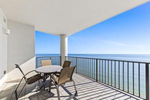 a balcony with a table and chairs and the ocean at The Oasis at Orange Beach in Orange Beach +175 photos