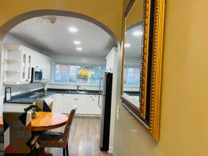 a kitchen with a table and a mirror on the wall at Holiday Home 7865LL in Niagara Falls