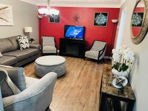 a living room with a couch and a tv at Holiday Home 7865LL in Niagara Falls