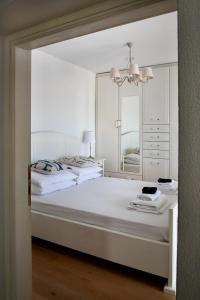 a bedroom with two beds and a mirror at PositiveSpace Kalamata Heights in Kalamata