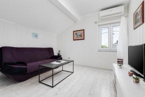 a living room with a couch and a table at Villa ZaVaLa Brzac in Brzac