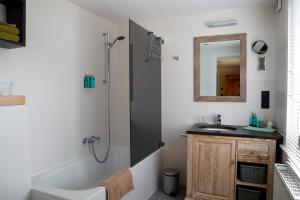 a bathroom with a sink and a shower and a mirror at B&B Chambres d'O in Ostend