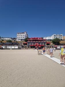 a group of people walking on the beach at EVA Studio Eforie Nord in Eforie Nord