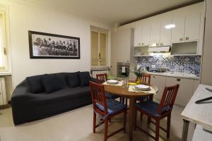 a living room with a couch and a table with chairs at Lovely Home Apartment in Lecco