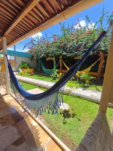a hammock on the porch of a house at Ecomar Pousada in São José da Coroa Grande