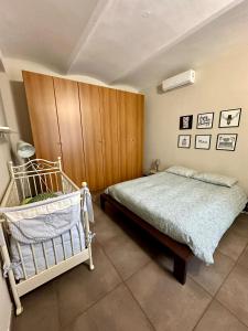 a bedroom with a bed and a wooden cabinet at Family Relais La Magnolia in Villanova dʼAsti +83 photos