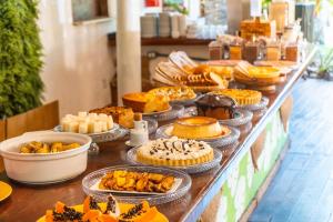 a buffet of pies and pastries on a table at Travel Inn Pousadas & Beach Club Trancoso in Trancoso