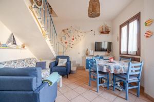 a living room with a table and chairs at Villa Corallina Relais & Climbing Center in San Vito lo Capo