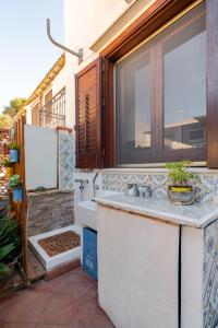 a bathroom with a sink and a window at Villa Corallina Relais & Climbing Center in San Vito lo Capo +95 photos