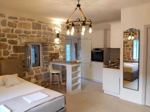 a kitchen and living room with a bed and a table at Stone sea apartment in Risan