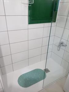 a shower with a green rug in a bathroom at Caleta Paraiso - Lovely Coastal Apartment in Costa de Antigua