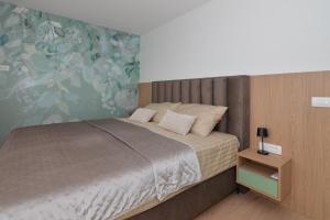 a bedroom with a bed and a wall at Sea House in Tkon