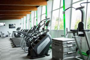 a gym with a row of treadms and elliptical machines at Fell Foot Lodge in Windermere