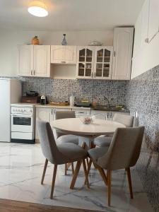a kitchen with a table and chairs in it at Apartment Vrbisao in Cetinje