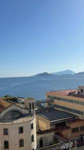 a view of a building with the ocean in the background at Casa Colò in Naples