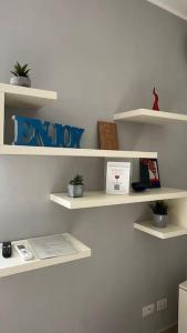 a room with white shelves on a wall at Casa Colò in Naples