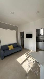 a living room with a blue couch and a television at Casa Colò in Naples