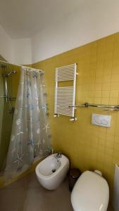 a bathroom with a sink and a toilet and a shower at Casa Colò in Naples +5 photos
