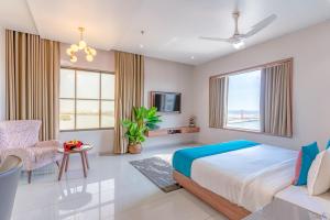 a bedroom with a bed and a couch at Pride Elite Dwarka in Dwarka