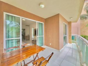 a dining room with a wooden table and chairs at Palm Beach | Porto das Dunas - CE in Mangabeira