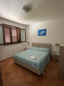 Postel nebo postele na pokoji v ubytování Ric&Cri - fronte mare - 4 posti letto - piscina