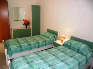 a room with two beds and a table and a mirror at Apartment Dependance-2 by Interhome in Santa Maria +2 photos