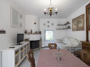 a living room with a table and a couch at Holiday Home Il Castagneto by Interhome in Taggia +22 photos