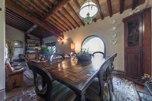 a dining room with a wooden table and chairs at Il Casolare delle Fiabe in Casole dʼElsa +32 photos