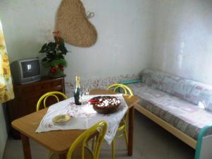 a room with a table and a bed and a table and chairs at Apartment Dependance-3 by Interhome in Santa Maria