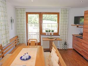 a living room with a table and a window at Apartment Hirsch by Interhome in See