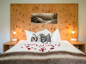 a bedroom with a bed with roses on it at Apartment Hirsch by Interhome in See