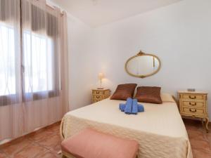 a bedroom with a large bed with a mirror at Holiday Home Omega by Interhome in L'Ametlla de Mar +13 photos