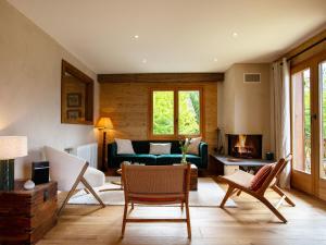 a living room with a couch and a fireplace at Chalet Chalet Shambala by Interhome in Chesières