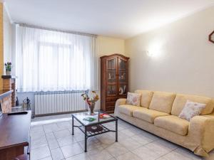 a living room with a couch and a table at Holiday Home Girasole by Interhome in Corrido