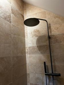 a shower with a shower head in a bathroom at Maison Nomade Perche - MaisonNomadeChic in Cour-Maugis-sur-Huisne +42 photos