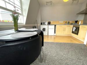 a kitchen with a table with a vase on it at Super Central Apartment in Heart of the City in Bristol +5 photos