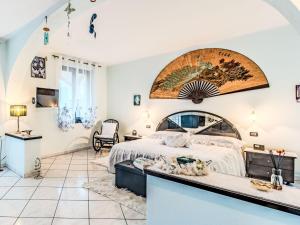 a bedroom with a large bed in a room at Apartment Nonna Grazia by Interhome in Lenno