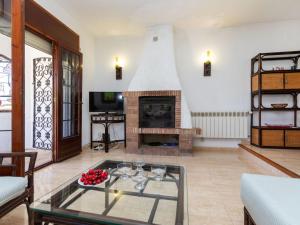 a living room with a fireplace and a table at Holiday Home Avellaner by Interhome in Miami Platja