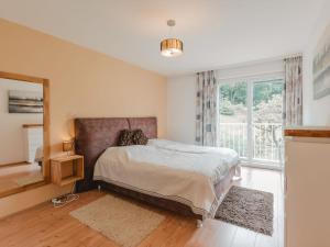 a bedroom with a bed and a large window at Holiday Home Rübezahl-3 by Interhome in Bad Hofgastein +22 photos