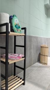 a shelf with a vase on it in a bathroom at Lungro's Square Apartment in Skopje