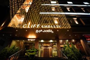 Un edificio con un cartel en el frente. en CLIFF EMBASSY BANQUET AND SUITEs, en Shimoga