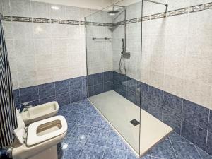 a bathroom with a toilet and a glass shower at Apartment Valentina by Interhome in Molina di Ledro +7 photos