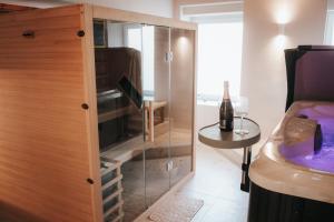 a bathroom with a glass cabinet with a sink at Luxury Residence Metlika in Metlika
