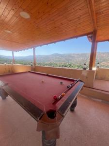 a pool table in a room with a view at Rooooz in Jerash