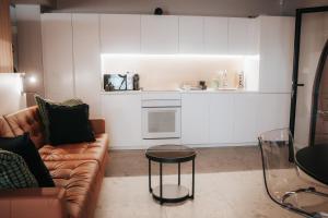 a living room with a couch and a table at Luxury Residence Metlika in Metlika +48 photos