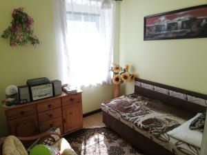 a bedroom with a bed and a dresser and a window at Jindřichov - Srdce Jeseníků in Šumperk