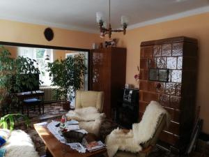 a living room with a table and two chairs and a table and a tableablish at Jindřichov - Srdce Jeseníků in Šumperk
