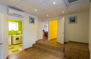 a kitchen with a staircase leading to a laundry room at Raigardo in Druskininkai +9 photos