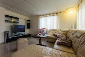 a living room with a couch and a tv at Raigardo in Druskininkai